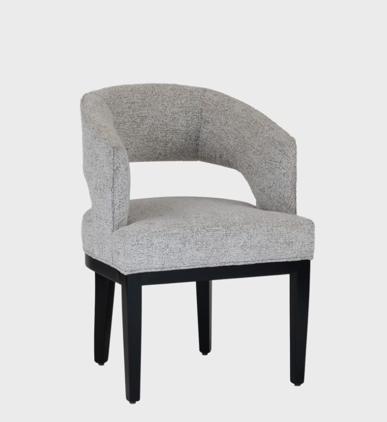 The Amur Dining Chair exudes refined comfort with its sculptural silhouette and curved backrest.