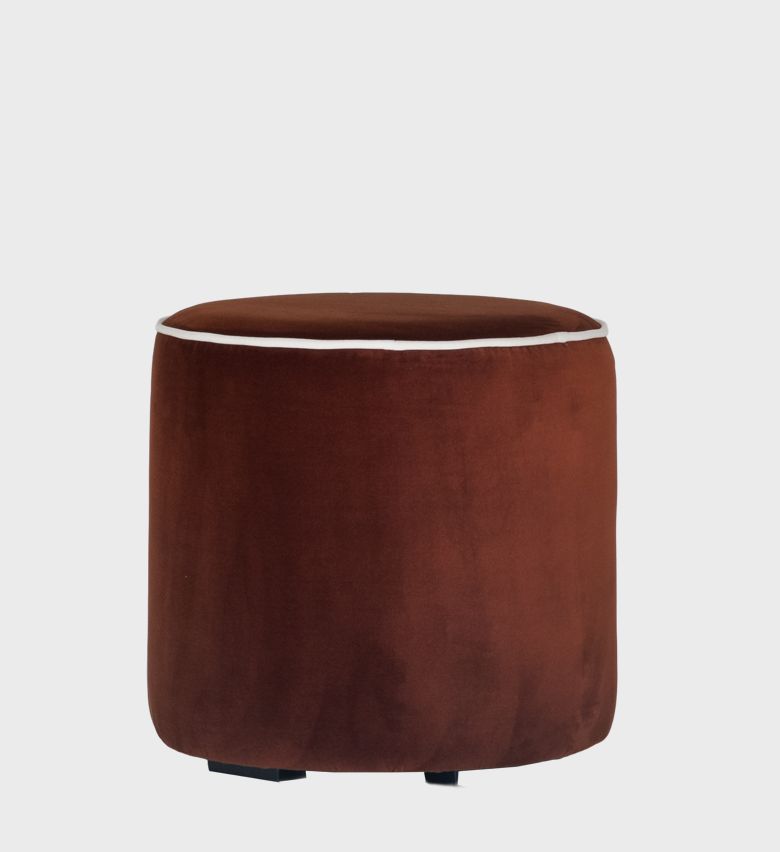 The Circle Ottoman offers a minimalist yet luxurious touch with its smooth cylindrical form and rich chestnut‑velvet upholstery.