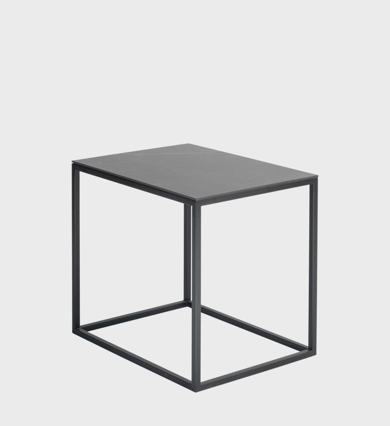 The Barcelona Side Table is a refined expression of minimalist design. Its rectangular black marble top, accented with subtle white veining, rests on a clean matte‑black metal frame that forms a perfect cube.