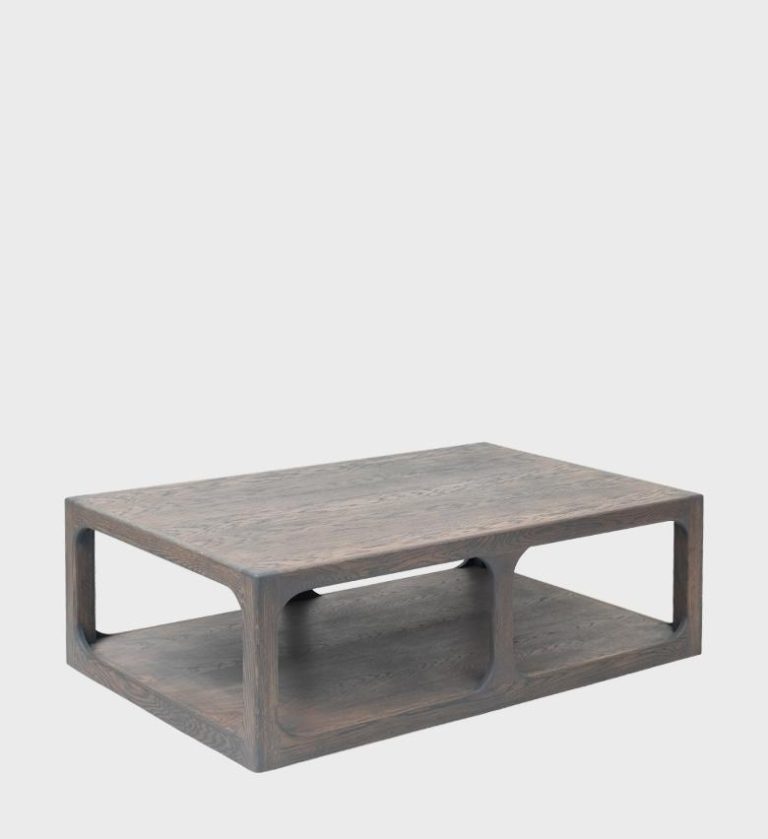The Clare Coffee Table is a bold expression of modern craftsmanship and functional design. Made from richly grained dark wood, it features a rectangular silhouette with softly rounded edges and open side cutouts that create a sculptural, airy feel.
