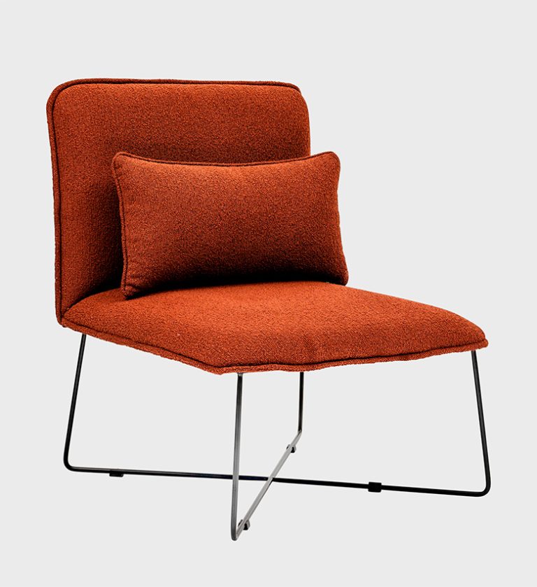 The Palma Chair is a striking example of minimalist comfort. Upholstered in a rich terracotta fabric, it features a sleek silhouette with a gently reclined back and a matching lumbar cushion for ergonomic support.