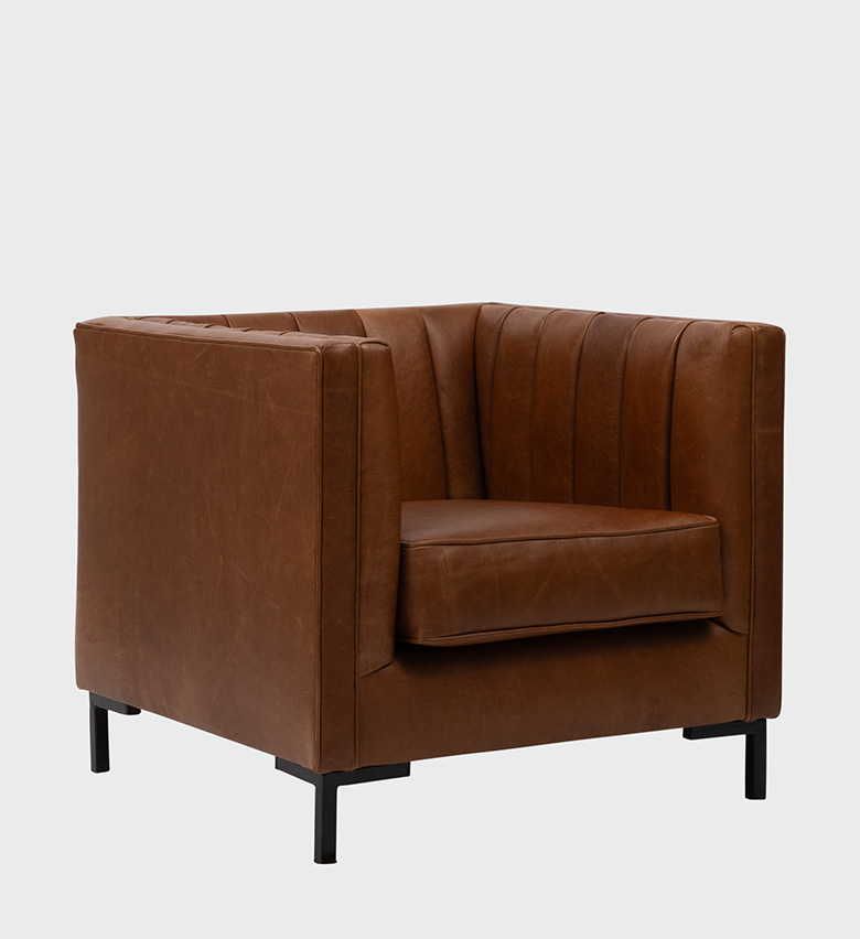 The Nappa Chair embodies sleek modern luxury with its structured silhouette and supple brown leather upholstery.