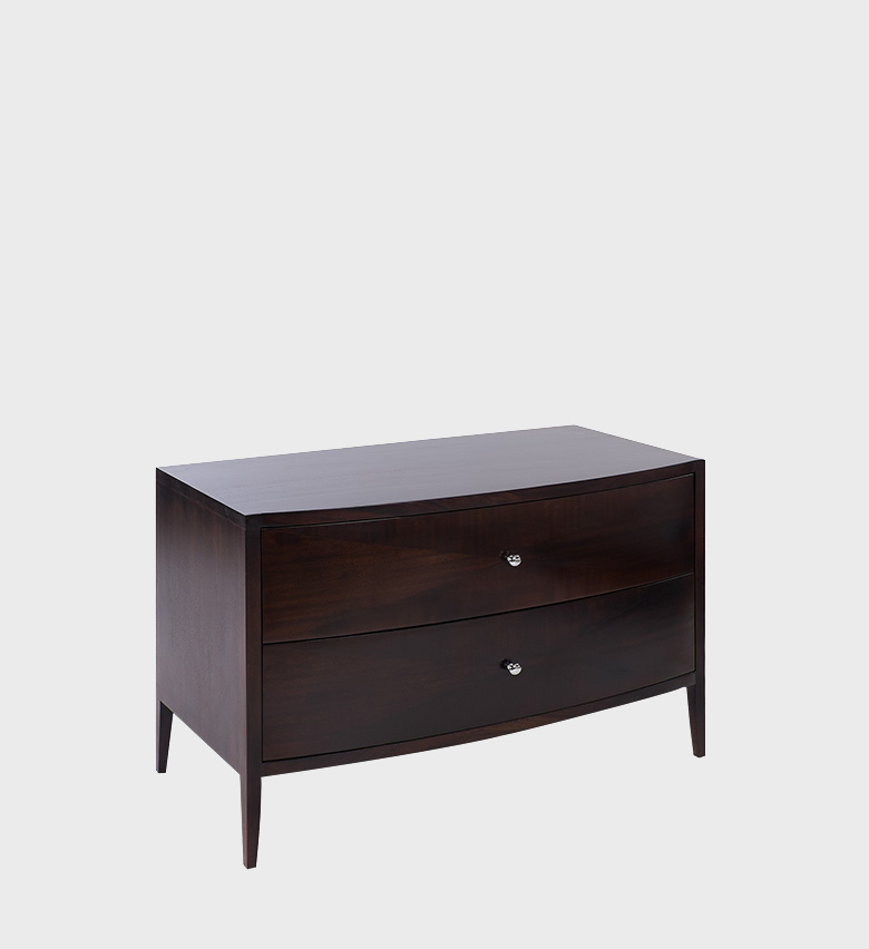 The David Chest MD embodies understated luxury with its smooth curved front and rich dark‑walnut finish. Featuring two spacious drawers accented by polished metal knobs, this piece combines timeless elegance with practical storage.